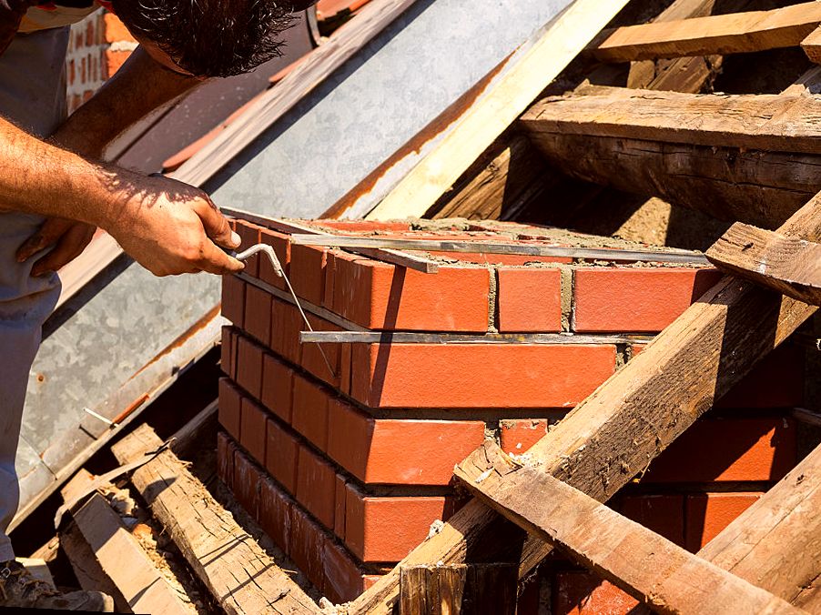 Brick bedded in fresh mortar on a rebuild
